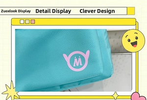 Detail shot of lake blue canvas backpack featuring a pink circular M logo and fabric texture