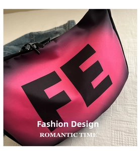 Detail view of pink and purple gradient crescent crossbody bag with FE letter print