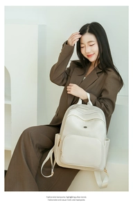 Close-up of minimalist white backpack with multi-compartments and premium matte finish