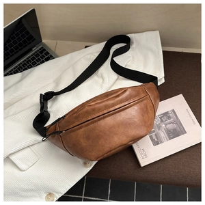 Detail of vintage brown textured leather crossbody bag with wide adjustable strap