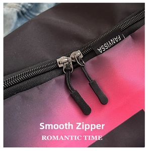 Close-up of smooth dual metal zippers and brand tag on red gradient nylon handbag