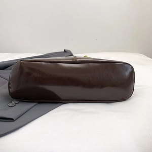 Bottom view of vintage burgundy leather shoulder bag with glossy finish and reinforced stitching