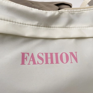Off-white canvas fashion handbag with pink letter print and secure zipper closure
