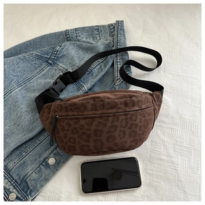 Close-up of brown leopard print suede chest bag with zipper and adjustable strap