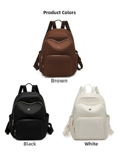 Three large capacity backpacks in brown, black, and white colors with metal zippers