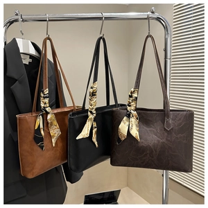 Three textured tote bags with decorative silk scarves in brown, black, and marble coffee