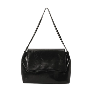 Fashionable black glossy tote bag with crinkled texture and silver chain strap