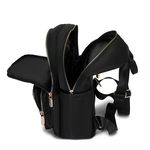 Large black nylon backpack with gold zippers and multi-compartment design for commuting