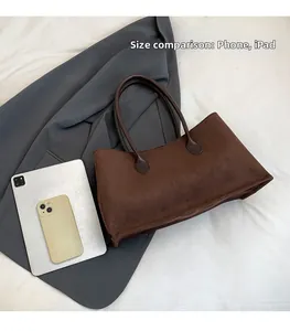 Brown suede tote bag size comparison with a phone and tablet showing large capacity