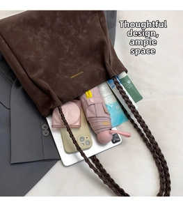 Detail view of brown suede tote bag interior capacity showing tablet, phone and umbrella