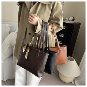 Three retro faux leather tote bags in brown, black and tan with decorative silk scarf