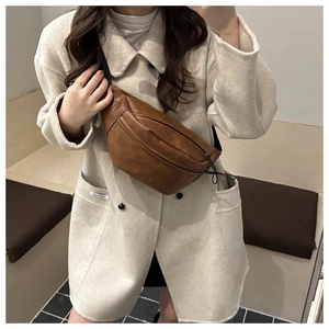 Close-up of vintage brown PU leather waist bag featuring multi-zipper compartments