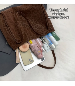 Top view of a spacious leopard print suede tote bag filled with daily essentials