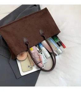 Top view of spacious interior of dark brown suede tote bag showing large capacity