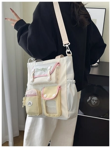 Detail of multi-pocket patchwork crossbody bag with embroidery and adjustable strap