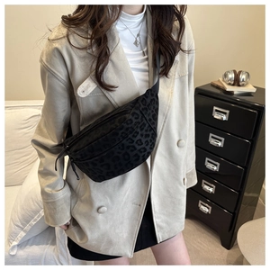 Detail of black leopard print crossbody bag with adjustable strap and zipper closure