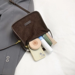 Deep brown matte suede handbag for women showing interior space for smartphone and cosmetics