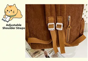Detail view of adjustable corduroy shoulder strap with white plastic buckles on brown backpack