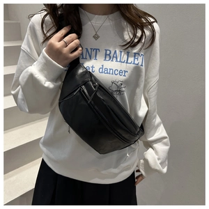Detailed view of the black PU leather crossbody chest bag shown on a model with zipper
