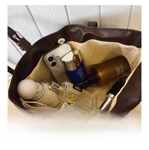 Deep brown tote bag interior showing large capacity for umbrella and daily essentials