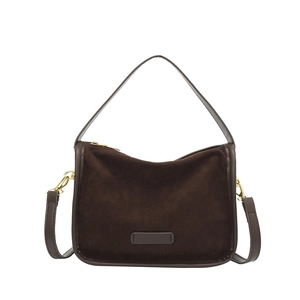 Dark brown suede crossbody bag with crescent shape and gold-tone zippers on white background