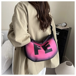 Detail of pink and black gradient crescent bag with FE lettering shown on model