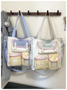 Detail of color-block canvas tote bags with multiple pockets and adjustable straps