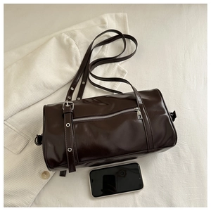 Detail of vintage brown Boston bag with silver zipper and phone for size reference