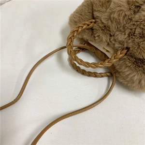 Brown faux fur cloud bag with woven leather handle and crossbody strap for winter