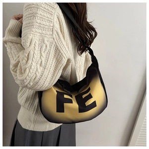 Macro view of gradient yellow and black crossbody bag with FE letter print details