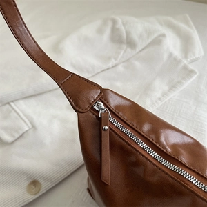 Minimalist brown vintage faux leather tote bag with smooth texture and zipper detail