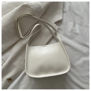Detailed view of cream-white bucket bag showing smooth faux leather texture and strap