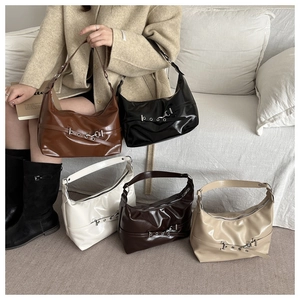 Detail showing five colors of retro leather hobo bags with metal eyelet belts and buckles