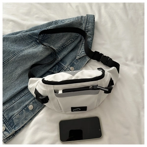 Detail of white nylon crossbody waist bag with black zippers and reflective webbing