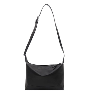 Minimalist black faux leather tote bag with adjustable strap and smooth matte finish