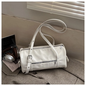 Close-up of white PU leather boston bag with dual silver zippers and metal eyelets