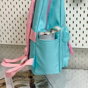 Blue and pink contrast school backpack with side pocket holding a water bottle