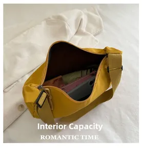 Detail view of bright yellow canvas crossbody bag showing spacious internal capacity