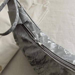 Silver metallic pleated shoulder bag with sleek zipper and chic bow texture detail