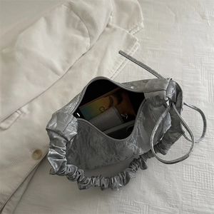 Silver metallic pleated shoulder bag with cloud-like handle and bow detail