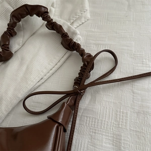 Dark brown pleated PU leather shoulder bag with elegant bow detail and stylish scrunched strap