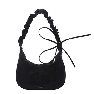 Minimalist black crescent shoulder bag with pleated strap and side ribbon bow detail