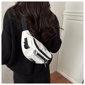 Detail of white nylon chest bag with reflective safety strip and adjustable black strap