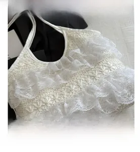 Detailed macro view of white lace tote bag with delicate floral crochet patterns