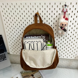 Brown corduroy backpack for students showing large capacity for books and laptops