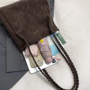 Large dark brown suede tote bag with woven strap showing high capacity for tablets and daily items