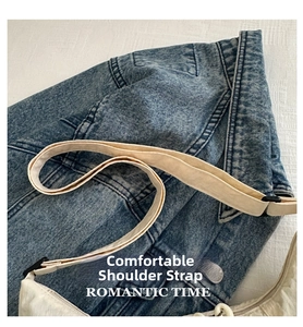 Detail of adjustable wide canvas shoulder strap on a cream white minimalist tote bag