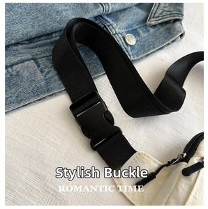 Detail of white sling bag showing black nylon shoulder strap and plastic side-release buckle