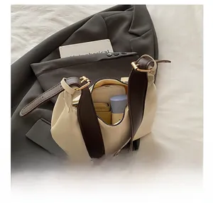 Spacious interior of beige leather underarm bag showing storage for phone and wallet