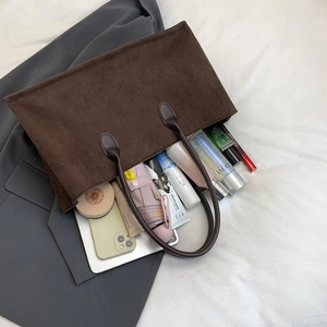 Brown corduroy tote bag showing large capacity for umbrella, phone, and cosmetics